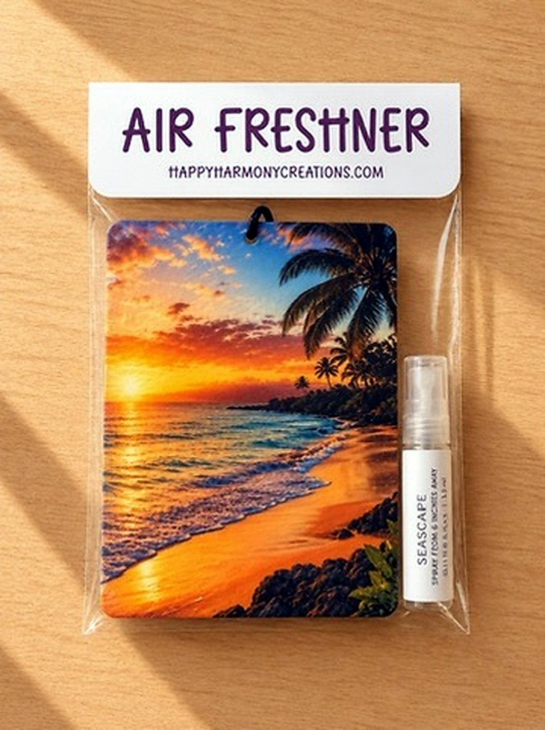packaged rectangular air freshener with beach sunset artwork and scent bottle