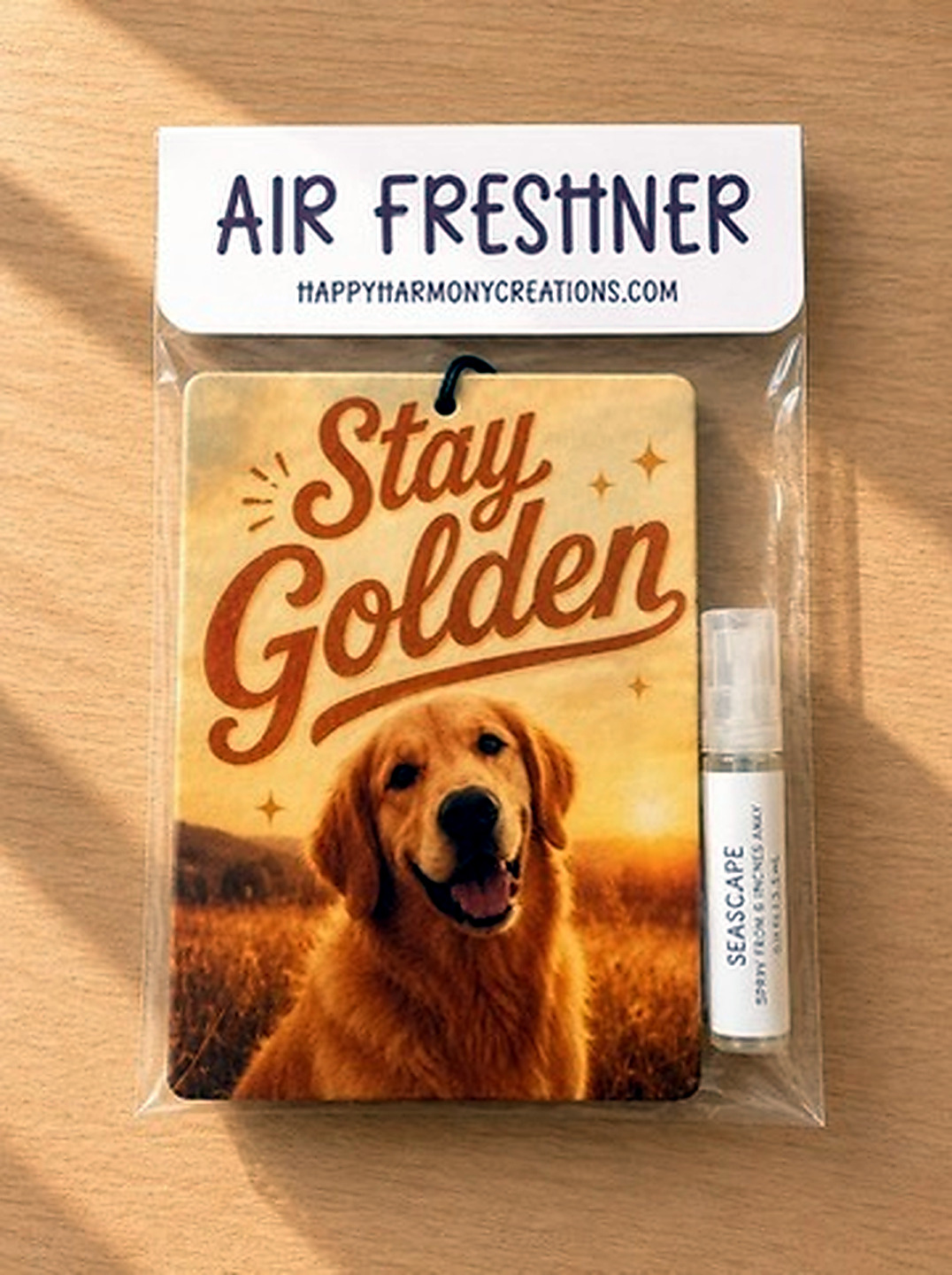 packaged rectangular air freshener with Stay Golden dog artwork and scent bottle